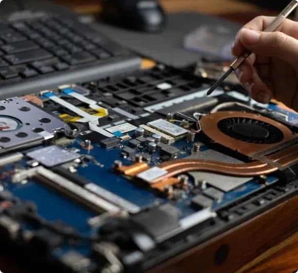 Green Wireless technician repairing an electronic device